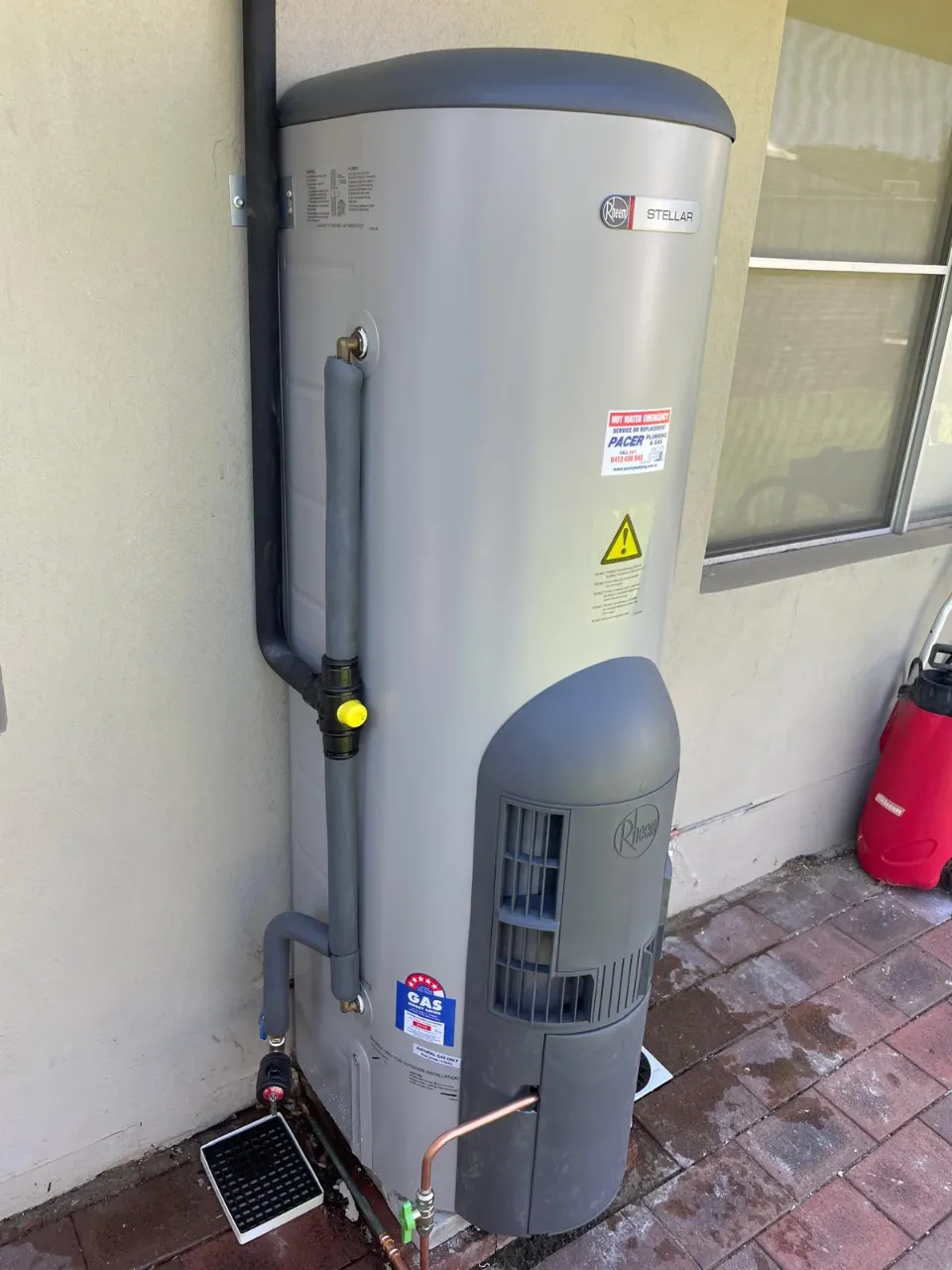 New Rheem Stellar gas storage hot water system installed in the same spot, with insulated pipework